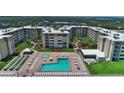 Aerial view of Castle Reef Condominiums, highlighting the pool and grounds at 4175 S Atlantic Ave # 4120, New Smyrna Beach, FL 32169