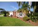 House exterior showcasing landscaping and a welcoming entrance at 2624 Turnbull Estates Dr, New Smyrna Beach, FL 32168