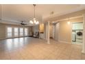 Spacious living room with tile floors and access to balcony at 424 Luna Bella Ln # 433, New Smyrna Beach, FL 32168