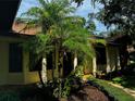 House entrance with tropical landscaping and walkway at 1780 Otisco Way, Winter Springs, FL 32708