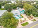 House with a large yard, driveway, and surrounding trees at 412 S Peninsula Ave, New Smyrna Beach, FL 32169