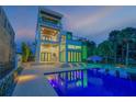 Three-story modern home with pool at dusk at 1194 N Peninsula Ave, New Smyrna Beach, FL 32169