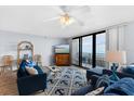 Ocean-view living room with comfy sofas and rug at 4139 S Atlantic Ave # B103, New Smyrna Beach, FL 32169