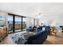 Spacious living room with ocean view and balcony access at 4139 S Atlantic Ave # B103, New Smyrna Beach, FL 32169