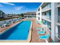 Resort-style pool with plenty of lounge chairs for relaxing in the sun at 3509 S Atlantic Ave # 209, New Smyrna Beach, FL 32169