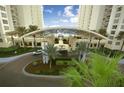 Elegant building entrance with a covered driveway and lush landscaping at 241 Riverside Dr # 510, Holly Hill, FL 32117