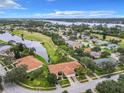 Aerial view of a beautiful home community near a golf course and lake at 1805 Turnbull Lakes Dr, New Smyrna Beach, FL 32168