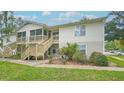 Two-story condo building with stairs and grassy area at 1600 Big Tree Rd # D2, South Daytona, FL 32119