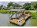 Private boat dock with covered area and a lift for easy access at 1206 S Riverside Dr, New Smyrna Beach, FL 32168