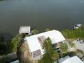Aerial view of a waterfront home showcasing its unique architecture at 824 Eel Ave, New Smyrna Beach, FL 32169