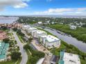 Aerial view showcasing condo building near waterway and marina at 426 Bouchelle Dr # 303, New Smyrna Beach, FL 32169