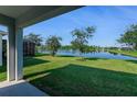 Serene backyard view of a pond with lush greenery at 422 Armoyan Way, New Smyrna Beach, FL 32168