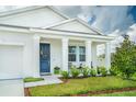 Inviting front porch with rocking chairs and lush landscaping at 5226 Hophorn Dr, Edgewater, FL 32141