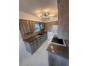 Modern kitchen with stone backsplash and wood cabinets at 840 Center Ave # 840, Daytona Beach, FL 32117
