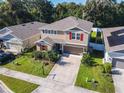 Two story house with tan siding, red shutters, and a two car garage at 1130 River Falls Cir, Deland, FL 32720