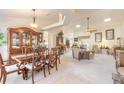 Open concept dining room flows into living room with neutral color palette at 5452 Saint Regis Way, Port Orange, FL 32128