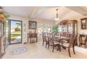 Bright dining room with wood table and chairs, and view to backyard at 5452 Saint Regis Way, Port Orange, FL 32128