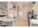 Modern kitchen with granite countertops and stainless steel appliances at 5452 Saint Regis Way, Port Orange, FL 32128