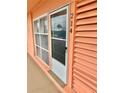Condominium building entrance with peach walls and white door at 721 S Beach St # 214A, Daytona Beach, FL 32114
