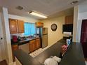 Bright kitchen with stainless steel appliances and wood cabinets at 900 S Peninsula Dr # 308, Daytona Beach, FL 32118