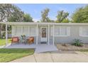 Front view of a charming house with a covered porch and manicured landscaping at 124 Hardin Pl, Edgewater, FL 32132