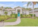 One-story home with teal door, landscaped yard, and two-car garage at 1768 Creekwater Blvd, Port Orange, FL 32128