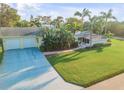 Attractive home with two-car garage, lush landscaping, and spacious yard at 501 S Peninsula Ave, New Smyrna Beach, FL 32169