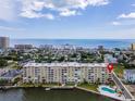 Aerial photo of condo building showcasing waterfront location and pool at 3606 S Peninsula Dr # 614, Port Orange, FL 32127