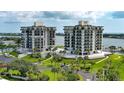 Aerial view of two waterfront condo buildings with tennis courts and marina at 501 N Causeway # 2050, New Smyrna Beach, FL 32169