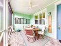 Screened porch with wooden table and chairs at 456 Lime Ave, Daytona Beach, FL 32124