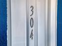 Close-up view of the front door with the number 304 at 1 Riverwalk Dr # 304, New Smyrna Beach, FL 32169