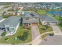 Two-story house with solar panels, paver driveway and landscaped yard at 2305 Santa Rosa Ct, Port Orange, FL 32128