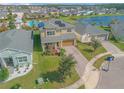 Two-story house with solar panels, paver driveway and landscaped yard at 2305 Santa Rosa Ct, Port Orange, FL 32128
