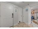 Bright entryway with white doors and nautical decor at 4141 S Atlantic Ave # 502, New Smyrna Beach, FL 32169