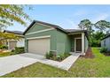 House exterior showcasing a two-car garage and curb appeal at 2352 Litchfield Loop, Deland, FL 32720