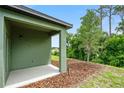 Covered patio with backyard access and wooded views at 2352 Litchfield Loop, Deland, FL 32720