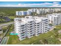Oceanfront building, unit #27 highlighted, with lawn and shuffleboard at 5303 S Atlantic Ave # 270, New Smyrna Beach, FL 32169