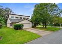 Tan two-story house with a two-car garage and mature landscaping at 172 Gull S Dr, Daytona Beach, FL 32119