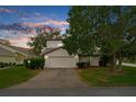 Tan two-story house with a two-car garage and mature landscaping at 172 Gull S Dr, Daytona Beach, FL 32119