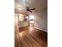 Living room with wood-look floors and a view into the kitchen at 1921 Jungle Rd, New Smyrna Beach, FL 32168