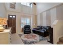 Spacious living room with high ceilings, leather furniture, and decorative rug at 3608 Romea Cir, New Smyrna Beach, FL 32168