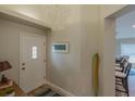 Bright entryway with white door and coastal decor at 682 Middlebury Loop, New Smyrna Beach, FL 32168