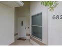 Front entrance with white door, window, and house number at 682 Middlebury Loop, New Smyrna Beach, FL 32168