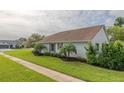 Side view of house showcasing landscaping and neighborhood at 682 Middlebury Loop, New Smyrna Beach, FL 32168