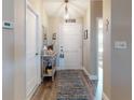 Inviting entryway showcasing a console table and hardwood floors at 803 Pine Shores Cir, New Smyrna Beach, FL 32168