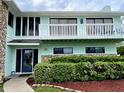 House entrance with a blue door and white railings at 1012 S Riverside Dr, Edgewater, FL 32132