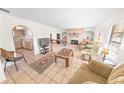 Spacious living room with tile floors, fireplace, and ample natural light at 110 Ponce Terrace Cir, Ponce Inlet, FL 32127