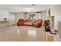 Living room with a sectional sofa and a brick fireplace at 1527 Magnolia St, New Smyrna Beach, FL 32168