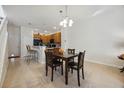 Kitchen and dining area with dark wood cabinets and a breakfast bar at 2681 Sweet Magnolia Pl, Oviedo, FL 32765