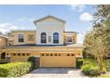 Front view of a two-story house with a two-car garage and well-manicured lawn at 2681 Sweet Magnolia Pl, Oviedo, FL 32765